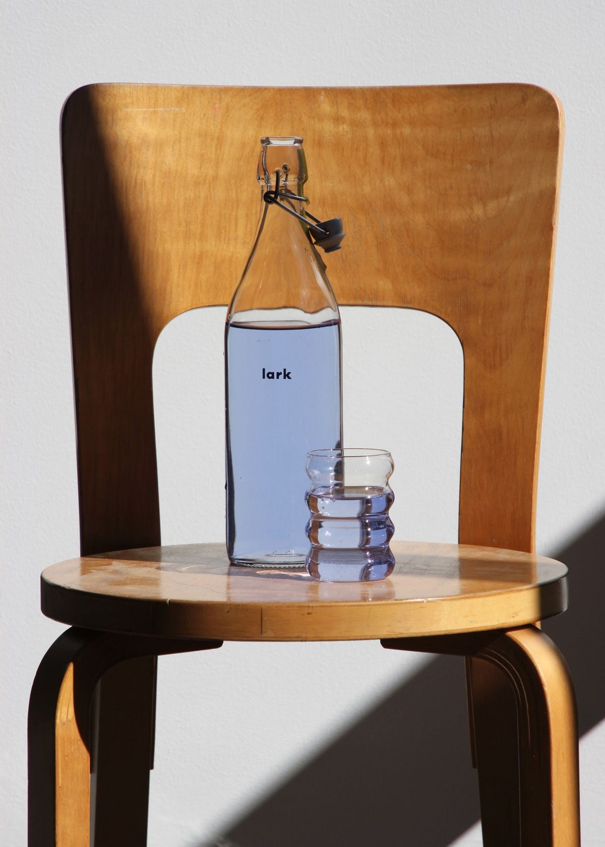 椅子の上に置かれた水色の「lark」とコップ