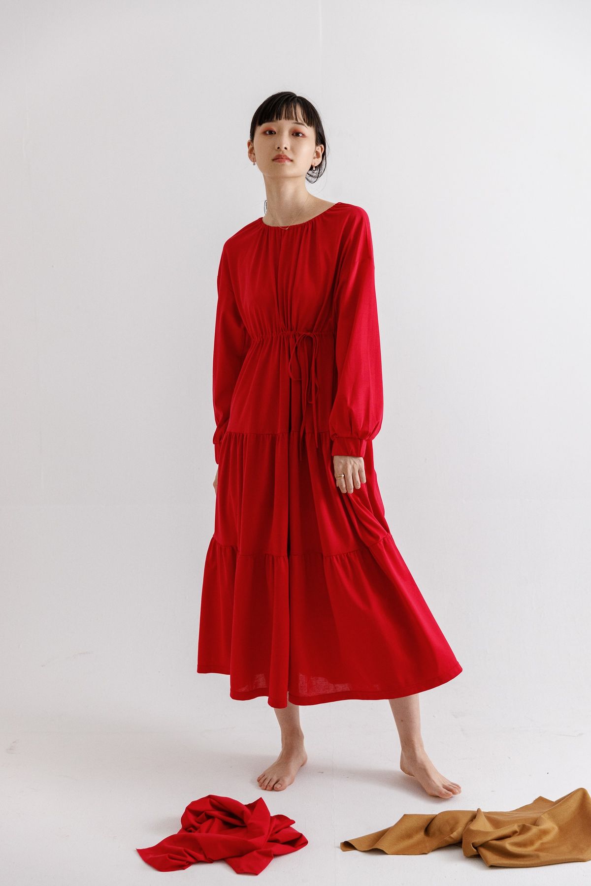 赤のワンピースを着用したモデル