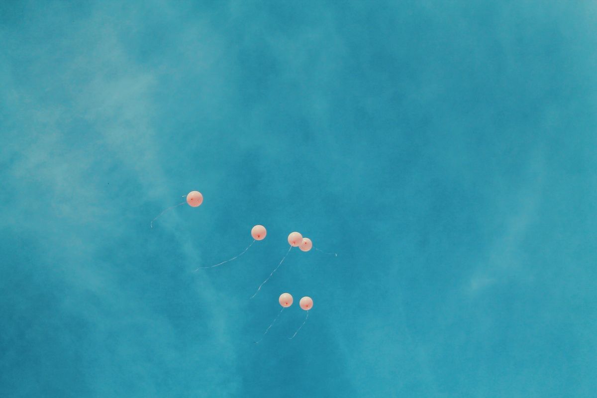 空を飛ぶオレンジ色の風船